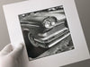 This photograph portrays the lines and curves of a classic American car. This is an original handmade black and white photograph printed by Keith Dotson in his darkroom on Ilford Classic Glossy gelatin silver fiber-based paper. This print is mounted on 4-ply acid-free white mounting board and sealed in a plastic sleeve for protection. Image size is approximately 7 x 7 inches. The mat size is 11 x 11 inches and it's ready to frame. Signed by the artist in pencil on the back of the mounting board.