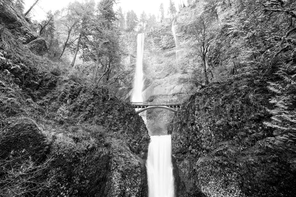 Black and white photograph of Oregon's famous two-tiered Multnomah Falls in winter.