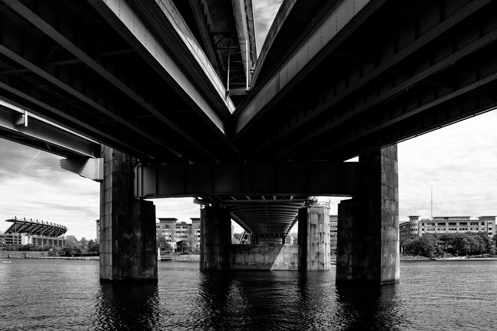 Black and white photograph of a bridge over the beautiful and wide Allegheny River, one of three major rivers found in the city of Pittsburgh.