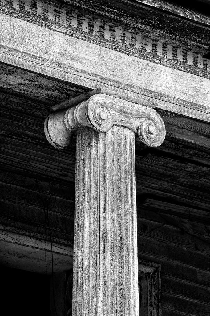Black and white photograph of cracked paint textures on an old wooden column on the historic abandoned Judge Mark Bird House built circa 1840 in Woodstock, Virginia. The house also once held the Woodstock Female Seminary.