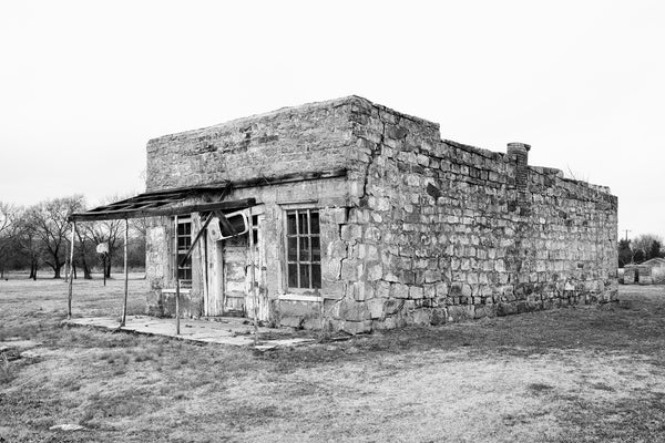 Black and white photograph of the historic abandoned Abe Lincoln Trading Company, built 1903 in Clearview, Oklahoma. It's better known as the Last Chance Bar or the Juke Joint, which occupied the building in later years. Structure was added to the National Register of Historic Places in December, 2023.