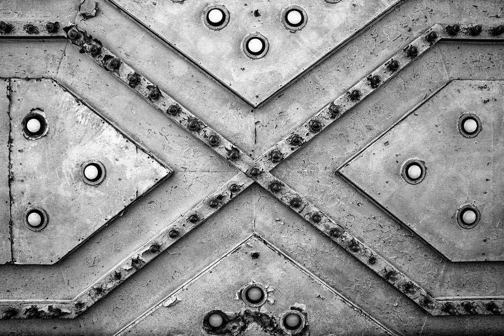 Black and white photograph of looking up at the rusty underside of an old theatre marquee over the sidewalk in downtown Los Angeles.
