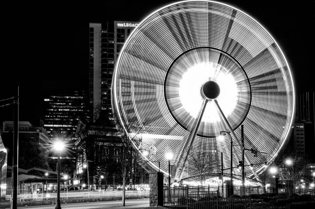 Black and white photograph of the famous Ferris Wheel in Atlanta's Centennial Park spinning at night.