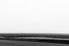 Black and white photograph of birds swirling in a blur over the flat and foggy Mississippi Delta farm landscape.