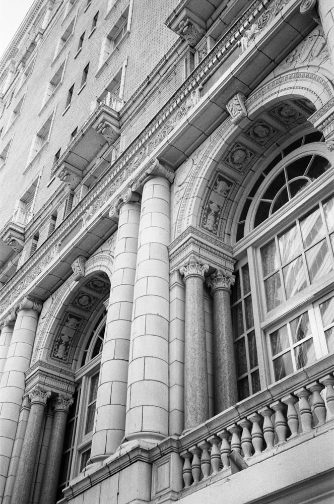 Black and white photograph of the front of the historic Hermitage Hotel in Nashville. This photograph was shot on 35mm Ilford Delta 400 black and white film. Note that your print will contain the characteristic film grain evident in film stock, which most people consider a desirable effect of analog film photography.