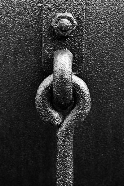Black and white photograph of a heavy metallic ring securely fastened through a strong loop. I thought this image made a perfect visual metaphor for strength, permanent bonds, and promises kept.