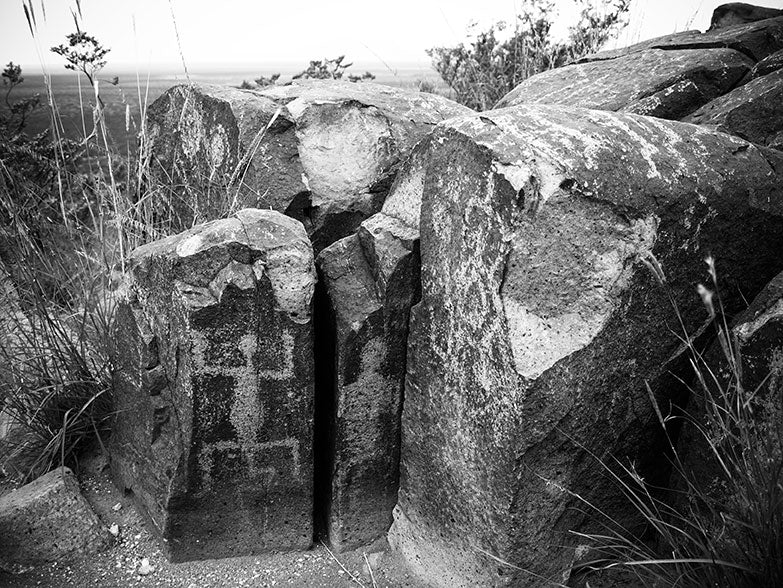 Black and white landscape photograph of an ancient Native American petroglyph at Three Rivers, New Mexico.