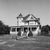 Black and white photograph of a beautiful big old house on a quiet street in a small town in the American Midwest. This photograph was shot on medium format black and white film using a vintage Hasselblad camera. Film photography provides a different look than digital photography and prints will display a pleasing amount of film grain and may appear somewhat softer than modern digital images. Be sure to look at the cropped detail images before buying.