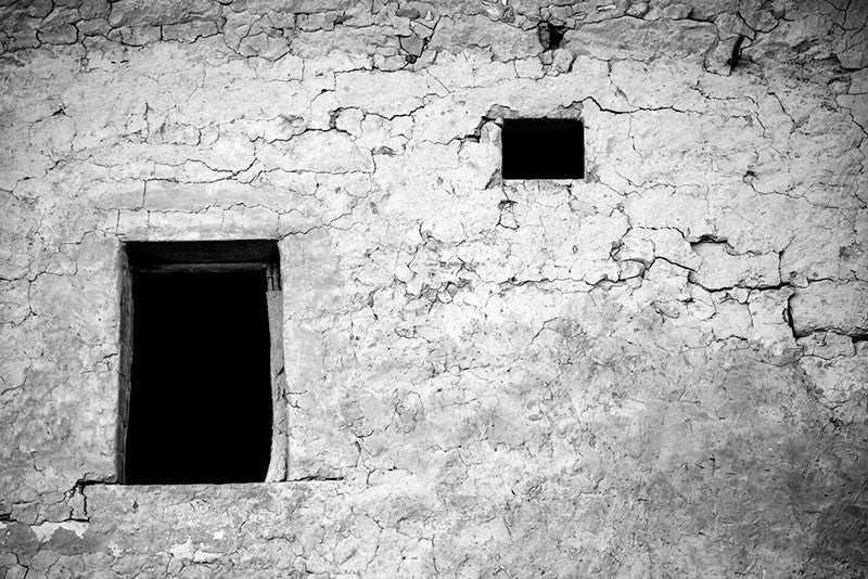 Black and white photograph of one of the centuries old mud and stone walls at Mesa Verde, Colorado.