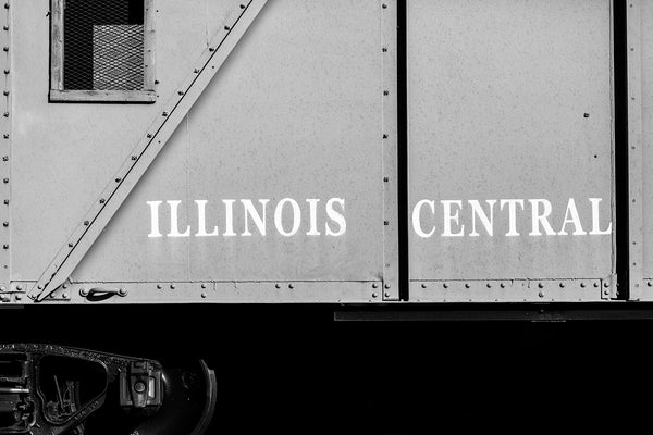 Black and white photograph of an old railroad car with the words Illinois Central on its side.