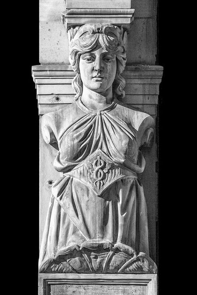 Black and white photograph of a Victorian era female sculpture on a historic building in downtown Paducah, Kentucky. This figurative architectural representation of a carved female figure is reminiscent of the famous Greek caryatids on the Parthenon in Athens.