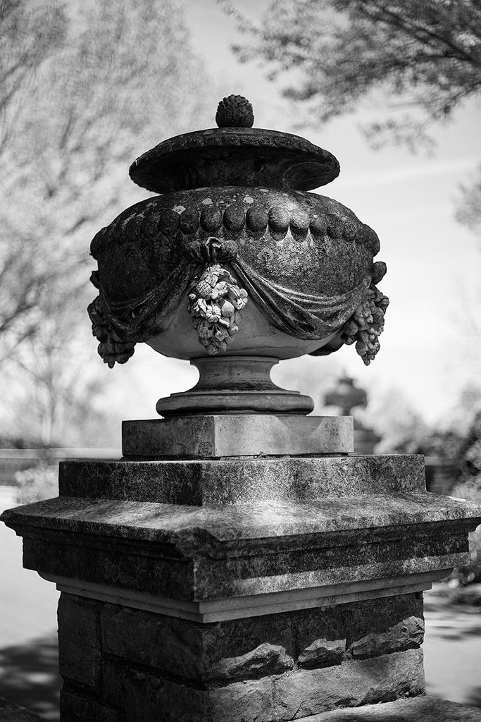Black and white photograph of a decorative urn statue on the exterior of Cheekwood Mansion in Nashville, Tennessee.