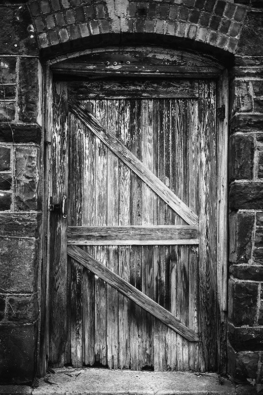 Black and white photograph of the wooden door to an abandoned industrial building located in downtown Birmingham, Alabama near Sloss Furnaces.