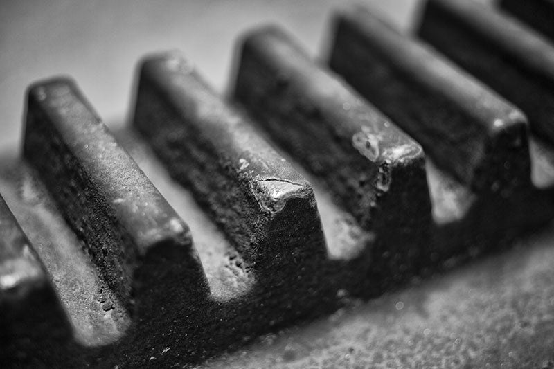 Black and white industrial photograph of a big gear teeth at defunct Sloss Furnaces in Birmingham, Alabama.