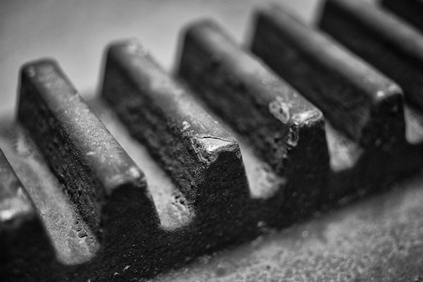 Black and white industrial photograph of a big gear teeth at defunct Sloss Furnaces in Birmingham, Alabama.