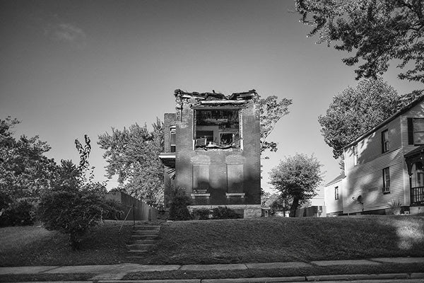 Black and white photograph of burned and abandoned row house in the College Hill neighborhood of St. Louis.