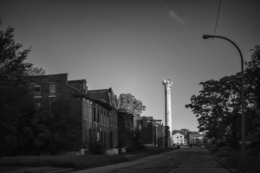 Black and white photograph of the historic Grand Avenue Water Tower, located on Grand Avenue at 20th Street in the College Hill neighborhood of St. Louis. Built in 1871 by George Barnett, the brick and iron tower was designed in the style of a Corinthian column, and is the oldest water tower in St. Louis.