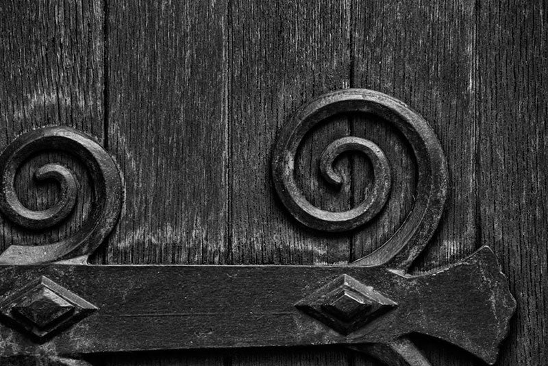 Black and white architectural detail photograph of the large wooden door on the exterior of the historic Christ Church in Nashville, Tennessee.