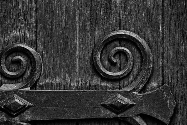 Black and white architectural detail photograph of the large wooden door on the exterior of the historic Christ Church in Nashville, Tennessee.