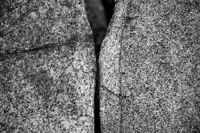 Black and white photograph of two large granite stones gracefully aligned on the Maine seacoast.