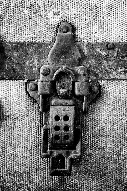 Black and white photograph a rusty latch on a canvas trunk that belonged to the late blues musician Sleepy John Estes. This antique trunk can be seen in his preserved house in Brownsville, Tennessee.
