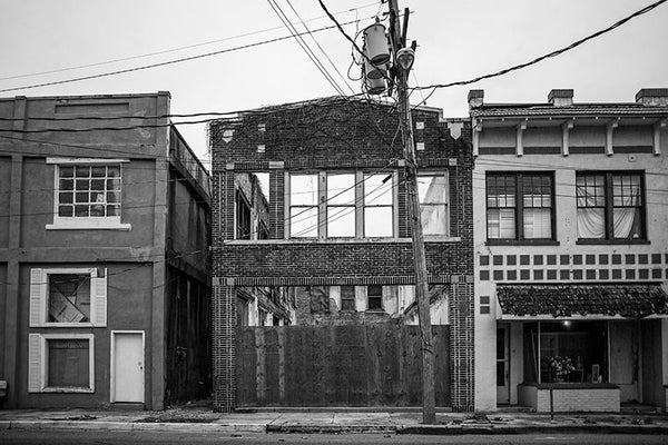 Black and white photograph of abandoned and collapsing buildings on 3rd Street in downtown Clarksdale, Mississippi.