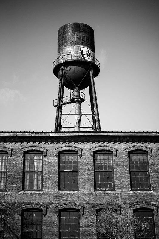 Black and white photograph of the Marathon Motor Works factory in Nashville, Tennessee. Built in 1881 to house the Phoenix Cotton Mill, the Nashville factory was used to manufacture automobiles from 1910 until 1914. The Marathon name was fitting with a Grecian craze that swept the country at the time.