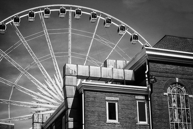 Black and white photograph of the giant white ferris wheel in downtown Atlanta, with the Tabernacle in the foreground.