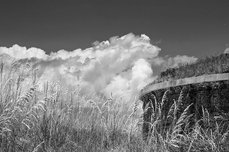 Black and white photograph of the Civil War-era Fort Massachusetts amidst the sand dunes on Ship Island, 12 miles off the coast of Mississippi in the Gulf of Mexico.