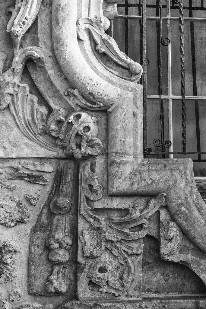 Black and white fine art detail photograph of a section of the famous Rose Window outside the church sacristy of Mission San Jose in San Antonio.