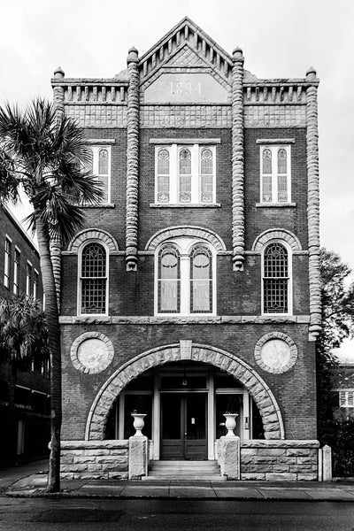 Black and white photograph of a unique historic building at 309 Meeting Street in Charleston. As the front of the building testifies, this beautiful structure was built in 1894 and served originally as the Connelley Funeral Home.