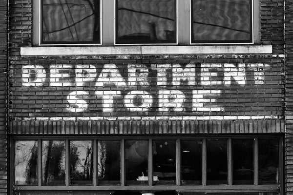 Black and white photograph of a vintage painted "Department Store" sign on the red bricks of an old building in the same Atlanta neighborhood as the Martin Luther King, Jr. birthplace and his former church. Perhaps Dr. King even shopped in this store