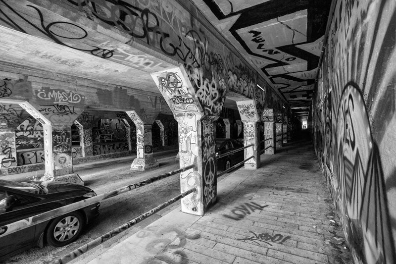 Black and white photograph of the famous Krog Street Tunnel street art site in the Cabbagetown neighborhood of Atlanta. This photograph is not available for commercial licensing.