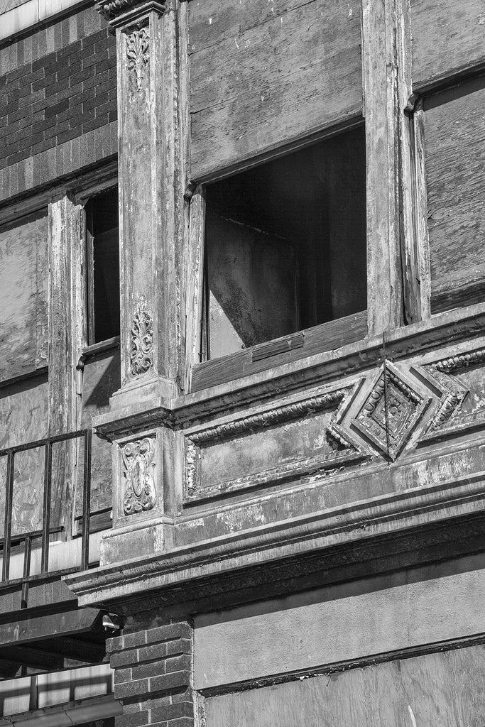 Black and white photograph of beautiful but abandoned commercial building that's been sitting empty for many years in Cairo, Illinois.