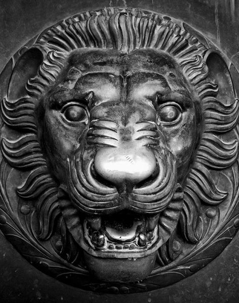 Black and white detail photograph of a lion head sculpture on one of the the huge bronze doors on the entrance to Nashville's replica of the Parthenon in Athens. Each of the four double-doors is 24 feet tall, one foot thick, and weighs seven and a half tons.