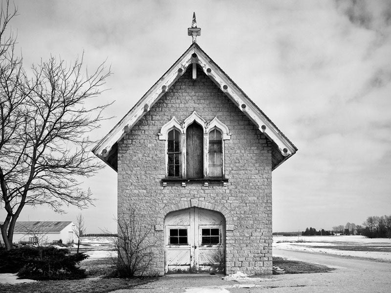 Black and white photograph of a carriage house and chapel, built 1840 on the prairie between Milwaukee and Madison, Wisconsin.