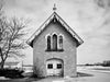 Black and white photograph of a carriage house and chapel, built 1840 on the prairie between Milwaukee and Madison, Wisconsin.