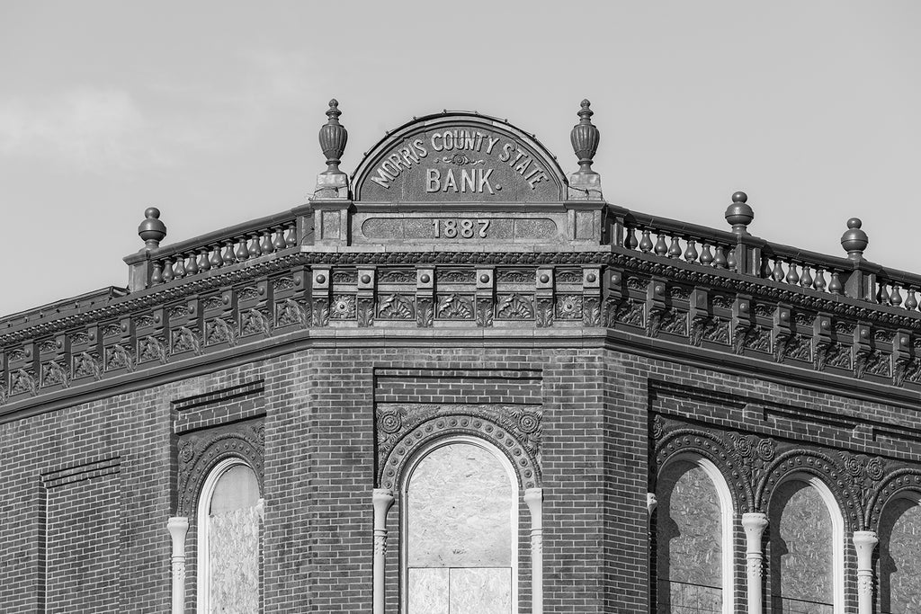 Black and white fine art photograph of the historic Morris County Bank, built 1887 on the old Santa Fe trail in Council Grove, Kansas. Along with the bank, the building housed a barber shop in the basement, a land office in the rear of the main floor, and offices for doctors and attorneys on the second floor.