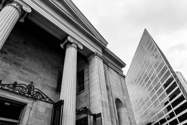 Black and white photograph of a historic downtown church juxtaposed against the razor's edge of an angular glass office tower in Nashville, Tennessee.