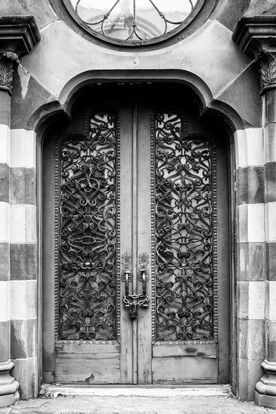 Black and white photograph of the historic old Farmers and Exchange Bank built in Moorish style in Charleston in 1853. The exterior doors and windows are covered with beautifully ornate old ironwork grills.
