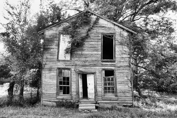 Black and white photograph of the front of the old Masonic lodge building in the ghost town of Rodney, Mississippi. 