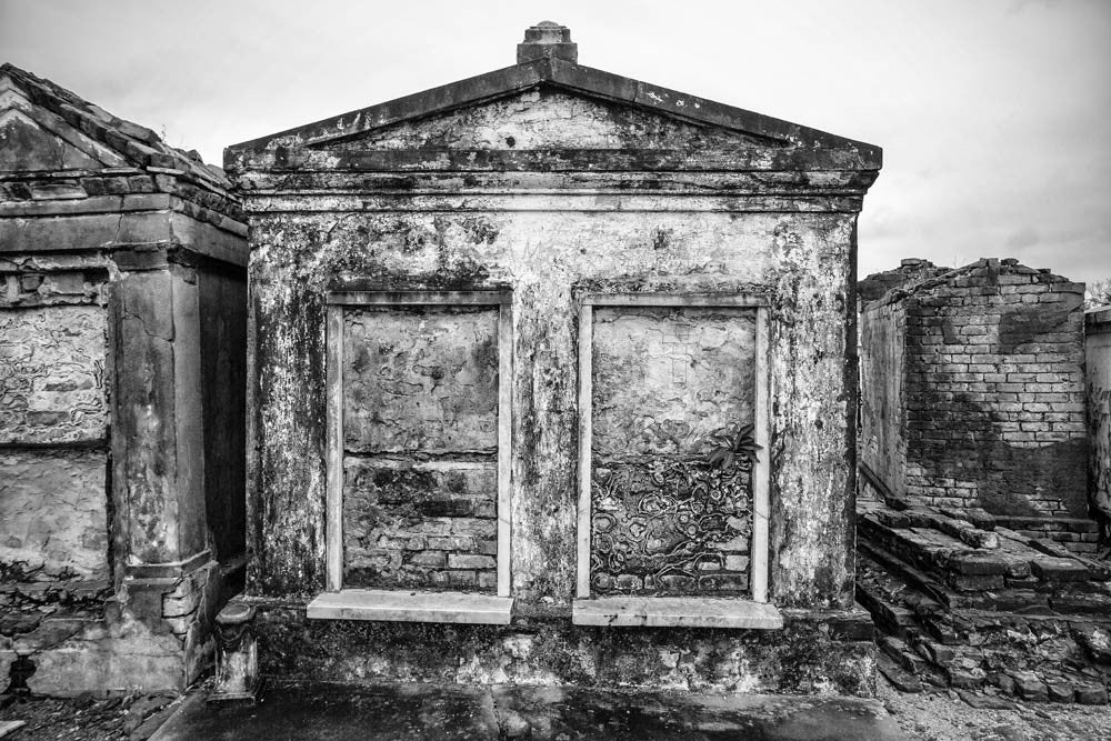 Black and white photograph of textured old above ground tombs in New Orleans' famous St. Louis Cemetery No. 1.