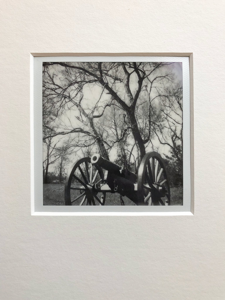 One-of-a-kind original black and white Polaroid photograph of an authentic cannon from the American Civil War seen on a historic battlefield site. Archivally mounted and overmatted with white 4-ply mat. Ready to fit an 11″ x 14″ frame.