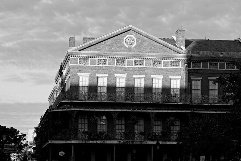 Black and white photograph of the sun setting on historic Jackson Square in the French Quarter of New Orleans. Jackson Square is a National Historic Landmark due to its role in the Louisiana Purchase in 1803.