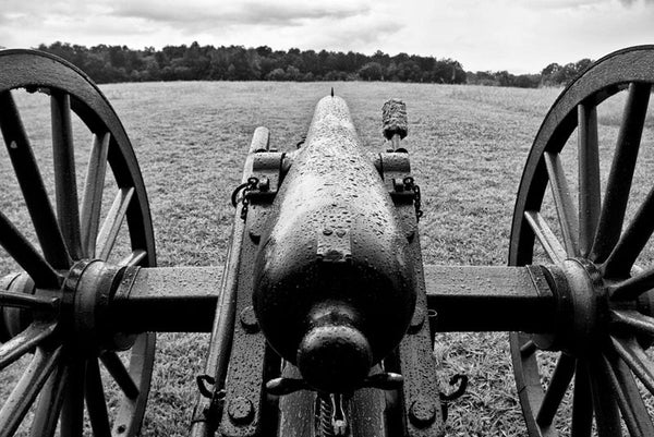 Black and white photograph of a black cannon, covered in rain drops, as it looks out over the landscape at the Chickamauga Battlefield, in Georgia, not far from Chattanooga, Tennessee.