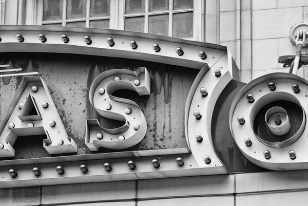 Black and white photograph of a section of the vintage Lucas marquee in Savannah, Georgia, focused on the shapes and textures of the sign's construction.