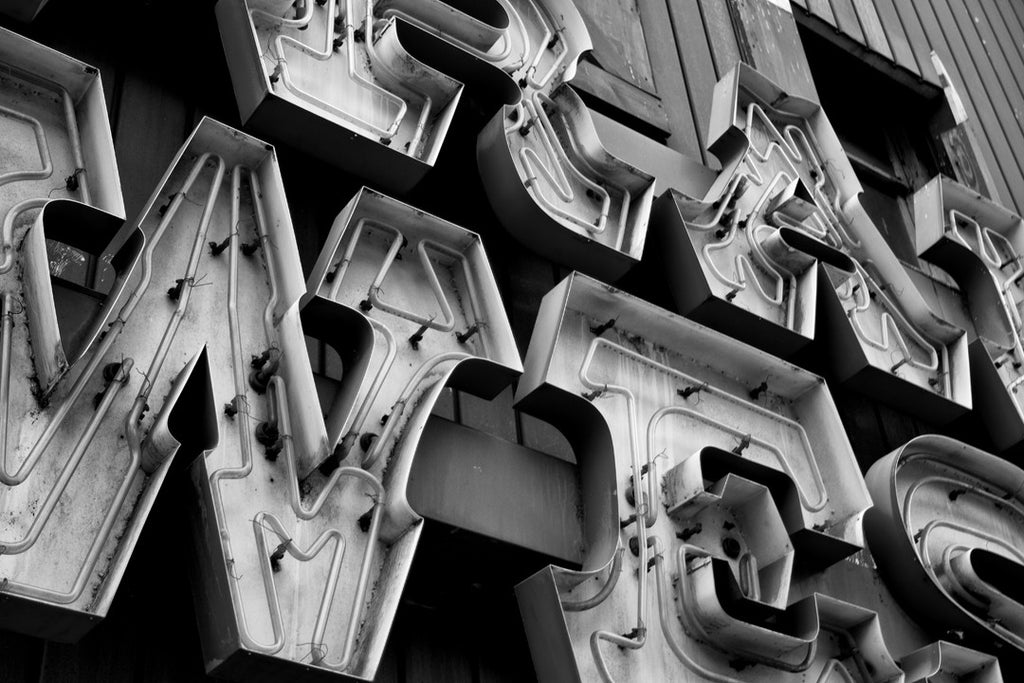 Black and white photograph of the Trail West neon sign that glowed over Lower Broadway in Nashville's honky tonk district for decades until the building was recently demolished.