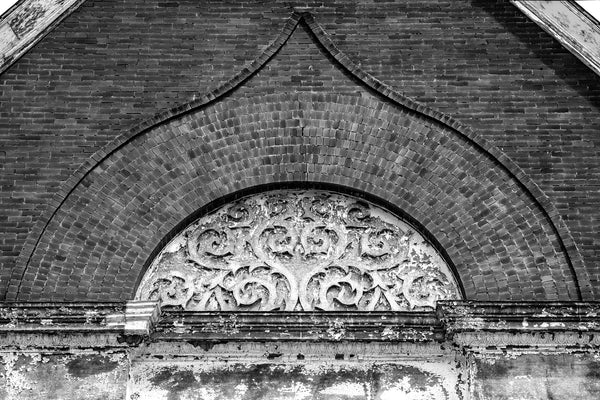 Black and white photograph of a brick apex with swirling floral patterns in the gable of the Third Presbyterian Church, built 1887 in South Wheeling, West Virginia.
