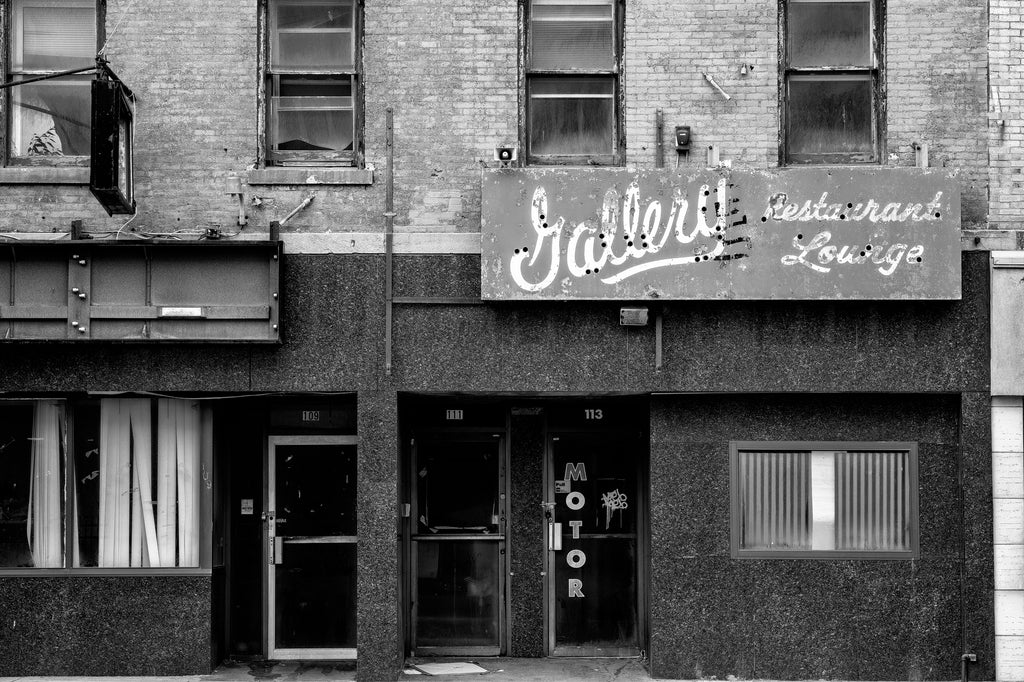 Black and white photograph of the grungy vacant Gallery Restaurant and Lounge in downtown Rochester, New York.