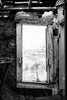 Set of two black and white photographs looking at the New Mexico landscape through two broken window frames found in ruined rooms of an abandoned motel along an isolated stretch of old Route 66.